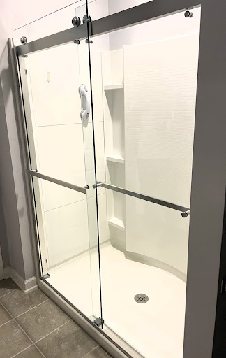 glass shower enclosure with hardware on the door