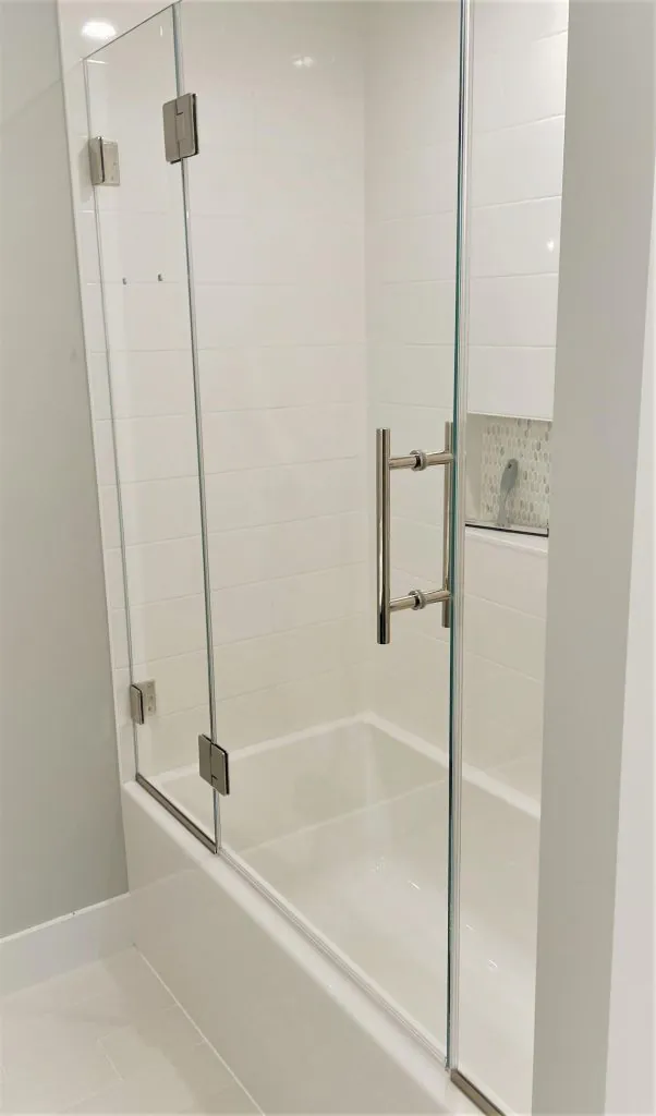 Centered glass bathtub doors offering symmetrical design.